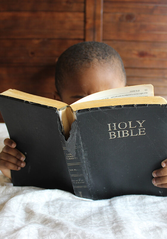 Kid Reading the Holy Bible